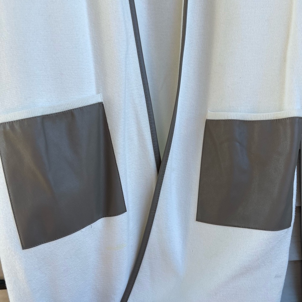 Chicos, size 1 sleeveless cardigan. Cream with faux leather gray trim.